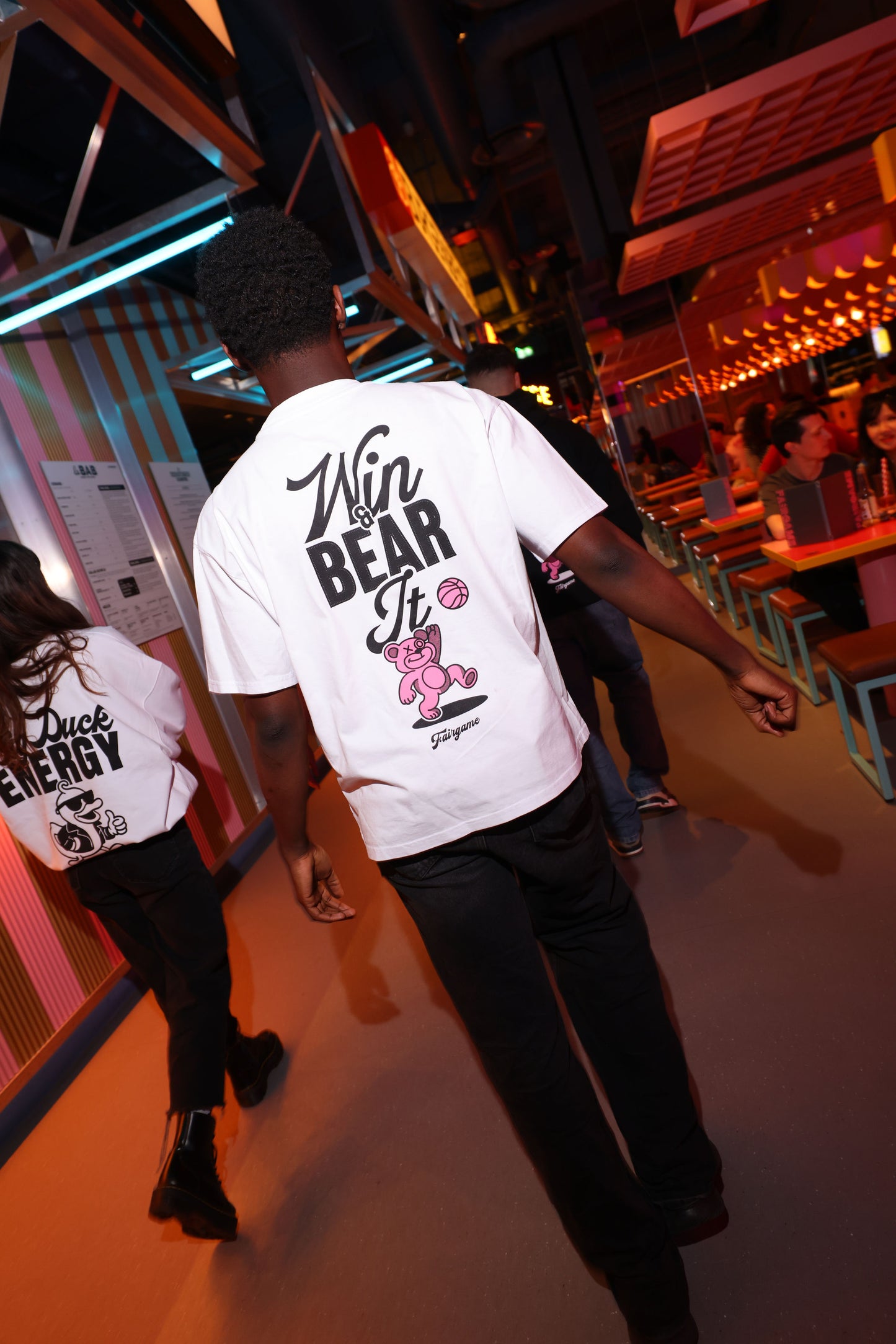 Person wearing a white t-shirt with graphic design in a casual setting